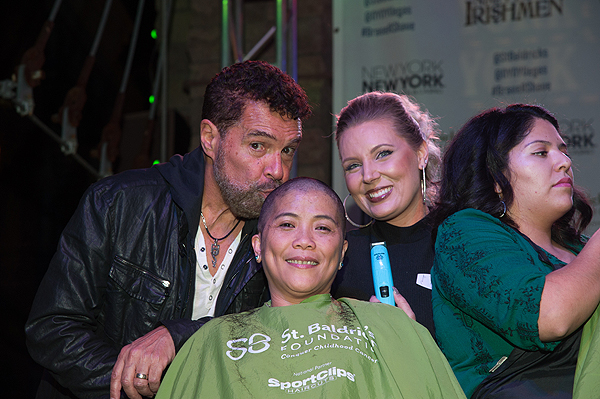Las Vegas entertainer Clint Holmes kisses the head of a shavee at the eight annual St. Baldricks Day at New York New York Hotel Casino