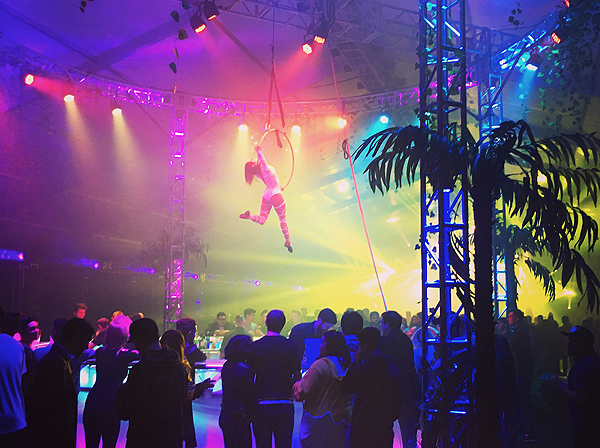 Interchanging aerial dancers perform over the roundabout bar
