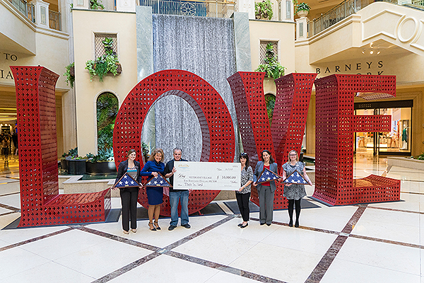 Team members from The Venetian and The Palazzo Las Vegas Present a 10000 check to Veterans Village Las Vegas CEO Arnold Stalk