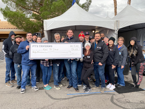 PTs Taverns Team Members Pose with 30000 Check Donation a