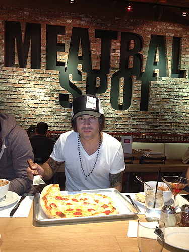 Ryan Cabrera with a pepperoni and pineapple pizza at Meatball Spot