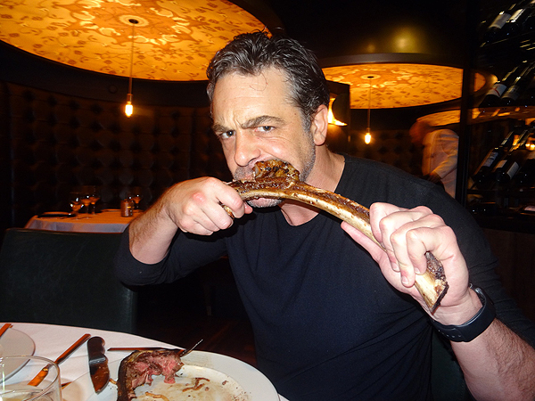 Actor Chris McKenna enjoys a long bone 32oz rib eye steak from Andiamo Steak House in Las Vegas